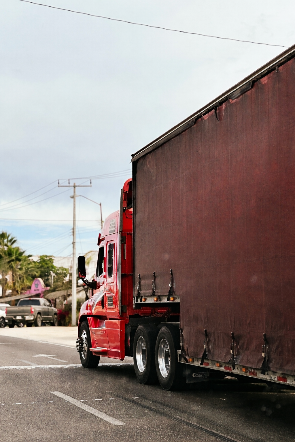 Red semi truck on suburban road | L-Transport, Votre partenaire de transport